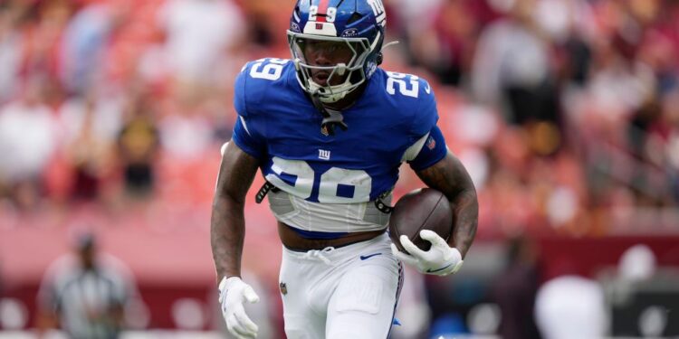 New York Giants football player running with the ball.