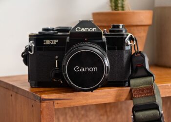 Photo of a Canon EF film camera sitting on a wooden shelf