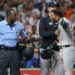 New York Yankees third baseman Jose Caballero (72) is held back by manager Aaron Boone while arguing with home plate umpire Ramon de Jesus after a call during the fourth inning against the Houston Astros at Daikin Park.