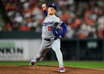 Los Angeles Dodgers pitcher throwing a baseball.