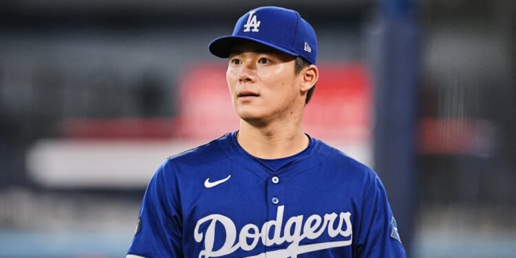 Dodgers player wearing a blue cap and jersey with number 18.