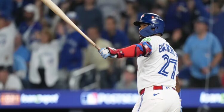 Toronto Blue Jays' Vladimir Guerrero Jr., left, watches his solo home run against the Seattle Mariners.