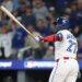 Toronto Blue Jays' Vladimir Guerrero Jr., left, watches his solo home run against the Seattle Mariners.