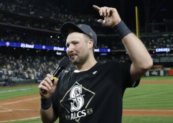 Cal Raleigh celebrates and addresses the fans after the Mariners' 15-inning win over Tigers in Game 5 of the ALDS.