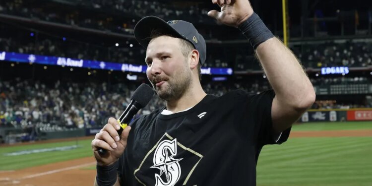 Cal Raleigh celebrates and addresses the fans after the Mariners' 15-inning win over Tigers in Game 5 of the ALDS.