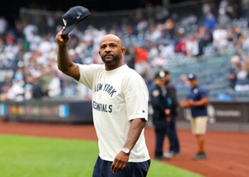 New York Yankees pinch hitter Clint Frazier #77 walks back to the dugout after striking out.