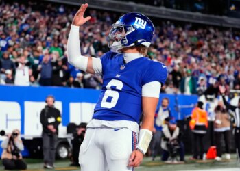 New York Giants' Jaxson Dart reacts after scoring a touchdown during the first half of an NFL football game against the Philadelphia Eagles Thursday, Oct. 9, 2025, in East Rutherford, N.J.