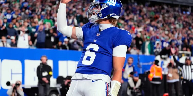 New York Giants' Jaxson Dart reacts after scoring a touchdown during the first half of an NFL football game against the Philadelphia Eagles Thursday, Oct. 9, 2025, in East Rutherford, N.J.