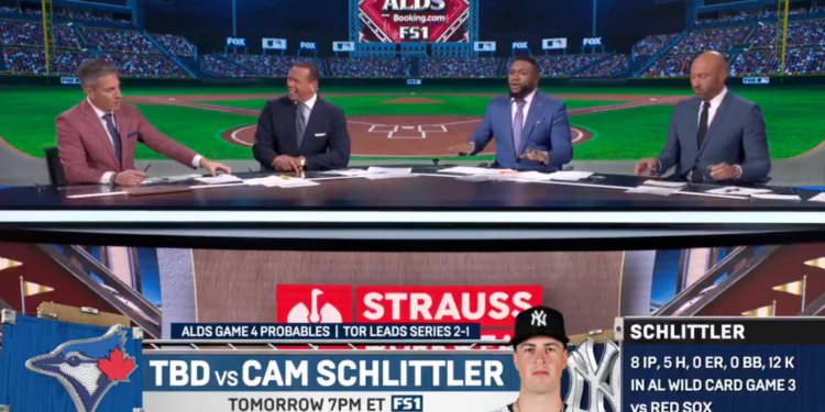 Four men in suits sitting at a table with a baseball stadium in the background, discussing the ALDS Game 4.