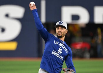 Los Angeles Dodgers shortstop Mookie Betts (50) throws the ball during World Series team workouts at Rogers Centre.