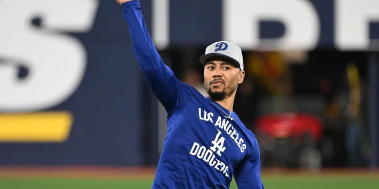 Los Angeles Dodgers shortstop Mookie Betts (50) throws the ball during World Series team workouts at Rogers Centre.