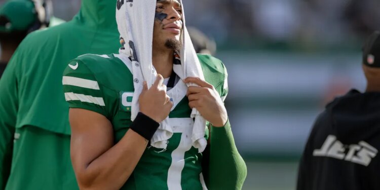 Jets quarterback Justin Fields (7) watches from the sidelines during the fourth quarter of an NFL football game against the Carolina Panthers, Sunday, Oct. 19, 2025, in East Rutherford, N.J.