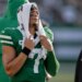 Jets quarterback Justin Fields (7) watches from the sidelines during the fourth quarter of an NFL football game against the Carolina Panthers, Sunday, Oct. 19, 2025, in East Rutherford, N.J.