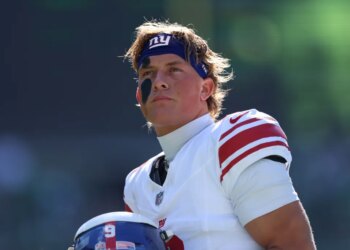 New York Giants quarterback Jaxson Dart (6) looking on before a game.