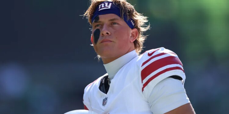 New York Giants quarterback Jaxson Dart (6) looking on before a game.