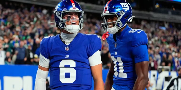 Jaxson Dart and Beaux Collins of the New York Giants celebrate a touchdown.