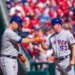 Pete Alonso and Glenn Sherlock of the New York Mets celebrate a hit with a fist bump.