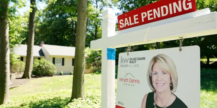 Real estate "SALE PENDING" sign in front of a house in Wyckoff, New Jersey.
