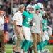 Miami Dolphins running back Ollie Gordon II (31) being helped off the field after an apparent injury.