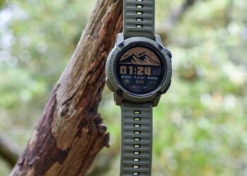 A Coros Nomad hangs from a tree branch