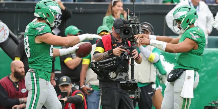 Philadelphia Eagles tight end Dallas Goedert #88 celebrates with Philadelphia Eagles quarterback Jalen Hurts #1 after he scores a touchdown during the fourth quarter.