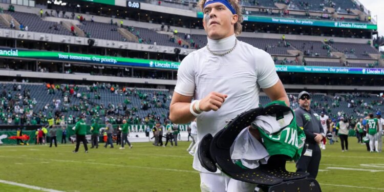 New York Giants quarterback Jaxson Dart (6) holding Saquon Barkley's jersey after the game.