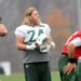Nick Mangold, a football player with the number 74, at practice holding a helmet.