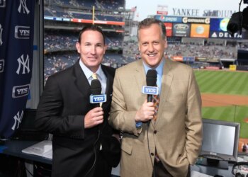 John Flaherty (l.), seen here with Michael Kay (r.), is out at YES Network after 20 years.