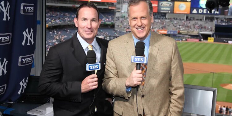 John Flaherty (l.), seen here with Michael Kay (r.), is out at YES Network after 20 years.
