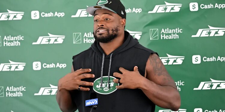 Jets guard John Simpson speaks to the media before practice at training camp in Florham Park, N.J.