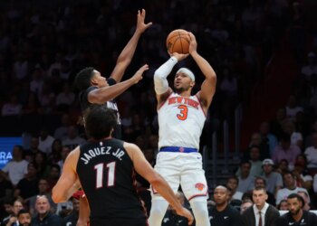 Knicks guard Josh Hart (3) shoots the basketball over Miami Heat guard Dru Smith (12) and forward Jaime Jaquez Jr. (11) during the third quarter at Kaseya Center.
