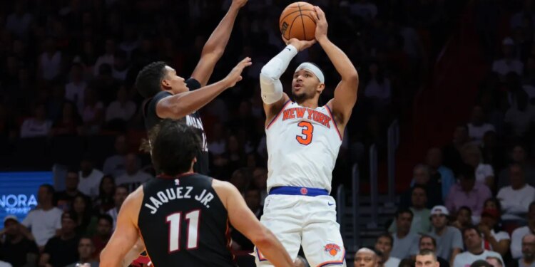 Knicks guard Josh Hart (3) shoots the basketball over Miami Heat guard Dru Smith (12) and forward Jaime Jaquez Jr. (11) during the third quarter at Kaseya Center.