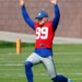 New York Giants place kicker Jude McAtamney stretching during football practice.