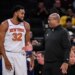 Karl-Anthony Towns talks with Mike Brown on Knicks sideline during an Oct. 9, 2025 preseason game.