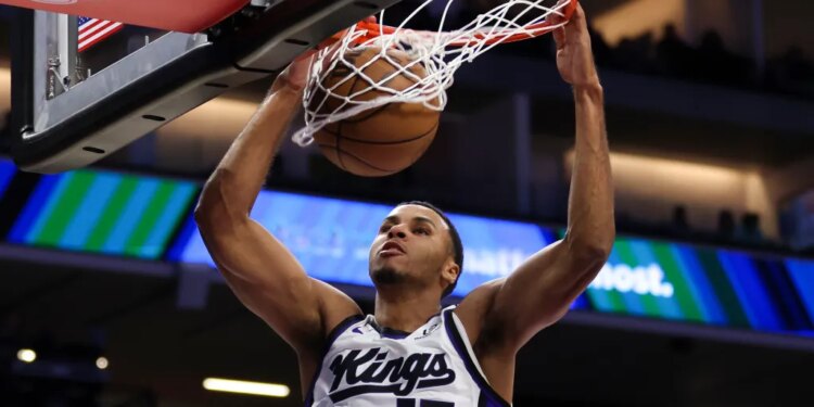 Sacramento Kings forward Keegan Murray dunks the ball during the first half of an NBA basketball preseason game against the Toronto Raptors, Wednesday, Oct. 8, 2025, in Sacramento, Calif.