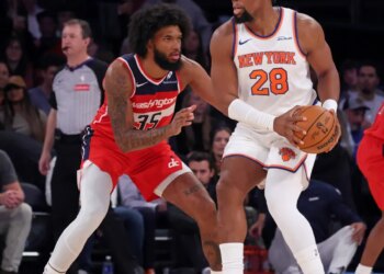 New York Knicks forward Guerschon Yabusele #28 looks for an opening as Washington Wizards Marvin Bagley III defends during the first quarter.