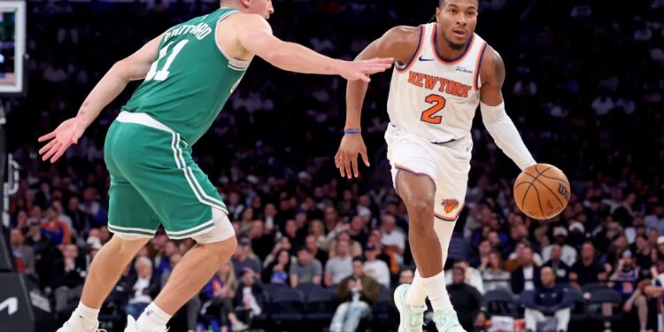 Miles McBride, who was placed in the starting lineup and scored 10 points, dribbles up court as Payton Pritchard defends during the Knicks' 105-95 win over the Celtics at the Garden on Oct. 24, 2025.