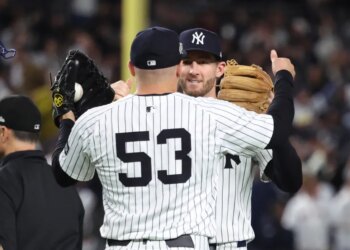 David Bednar #53 of the New York Yankees greets Ryan McMahon