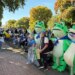 Protesters pose for photos with a trio of inflatable frogs at the October No Kings protest in downtown Portland.