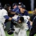 Jorge Polanco (center) is mobbed by teammates after ripping a game-winning single in the 15th inning of the Mariners' win over the Tigers in Game 5 of the ALDS on Oct. 10, 2025.