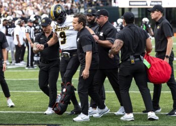 Missouri quarterback Beau Pribula (9) is assisted off the field by medical staff.