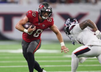Tampa Bay Buccaneers tight end Cade Otton (88) runs with the ball after a recpetion as Houston Texans safety Jalen Pitre (5) attempts to make a tackle during the fourth quarter at NRG Stadium.