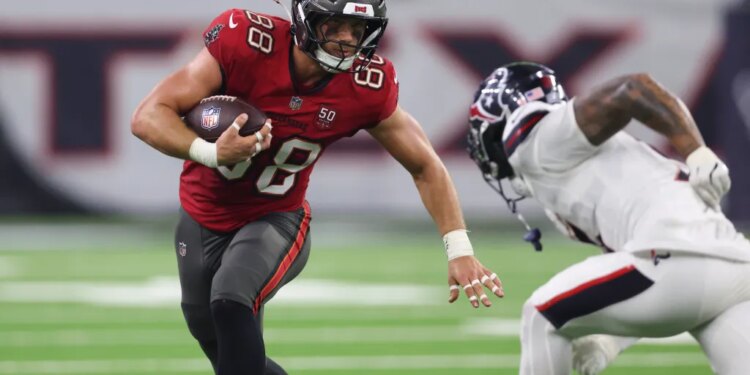 Tampa Bay Buccaneers tight end Cade Otton (88) runs with the ball after a recpetion as Houston Texans safety Jalen Pitre (5) attempts to make a tackle during the fourth quarter at NRG Stadium.