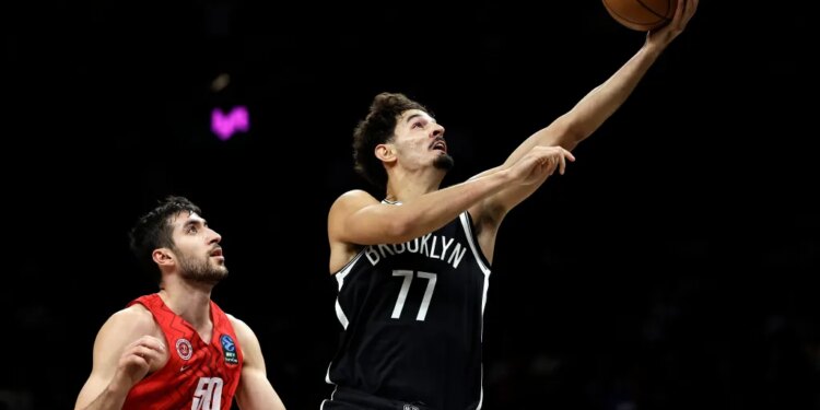 Ben Saraf goes up for a shot after driving past Yovel Zoosman during the Nets' 123-88 round over Hapoel Jerusalem at Barclays Center on Oct. 4, 2025.