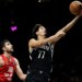 Ben Saraf goes up for a shot after driving past Yovel Zoosman during the Nets' 123-88 round over Hapoel Jerusalem at Barclays Center on Oct. 4, 2025.