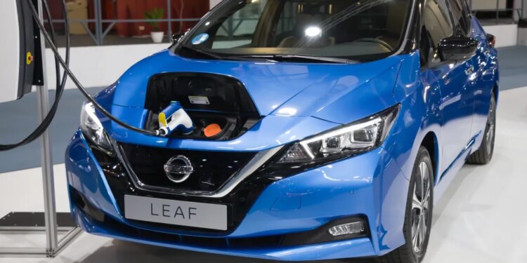 Blue Nissan Leaf e+ Tekna electric car charging at Automobile Barcelona 2021.
