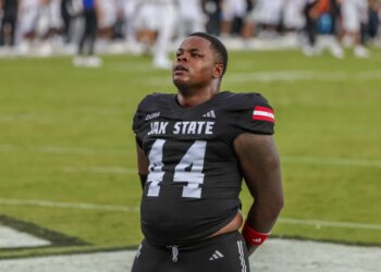 A Jacksonville State Gamecocks football player in a black jersey with the number 44 pauses on the field.