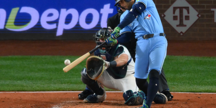George Springer of the Toronto Blue Jays hitting an RBI double against the Seattle Mariners.