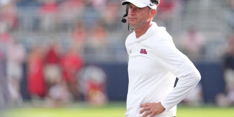 Mississippi head coach Lane Kiffin looking downfield at his team.