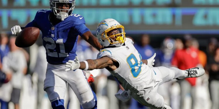 Cornerback Paulson Adebo, who will be facing his old team, the Saints, on Sunday, breaks up a pass intended for Keandre Lambert-Smith during the Giants' Week 4 win over the Chargers.